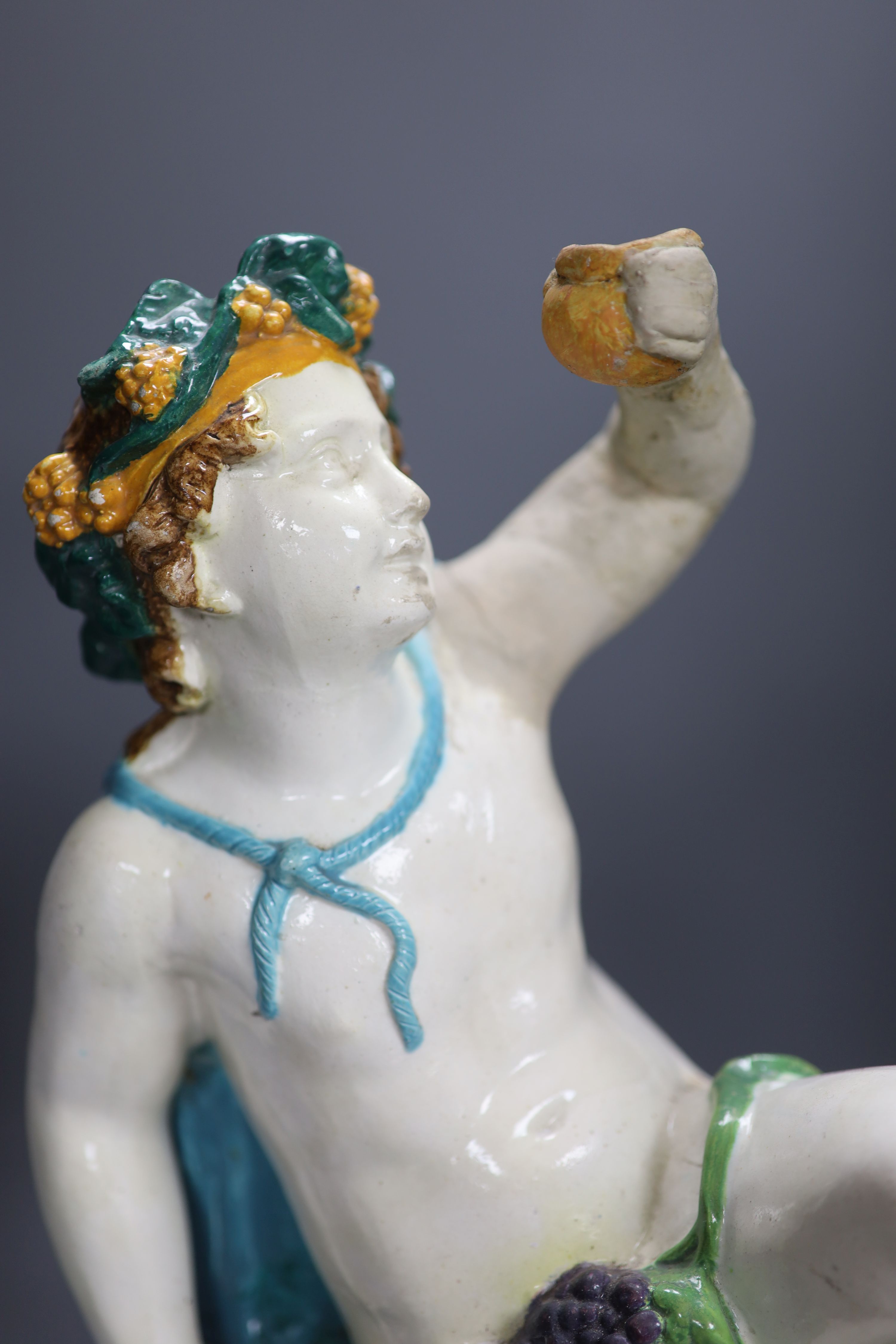 A majolica pottery figure of Bacchus, height 47cm (a.f.)